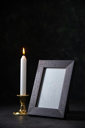 front-view-white-candle-with-picture-frame-dark_179666-42173.jpg